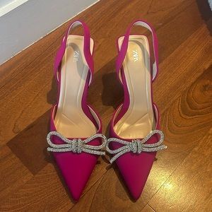 Pink satin heels with embellished bow
